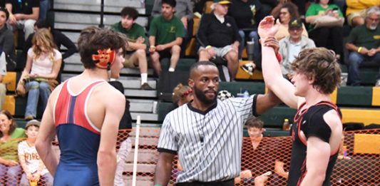 Mountain men crowd the wrestling award stand
